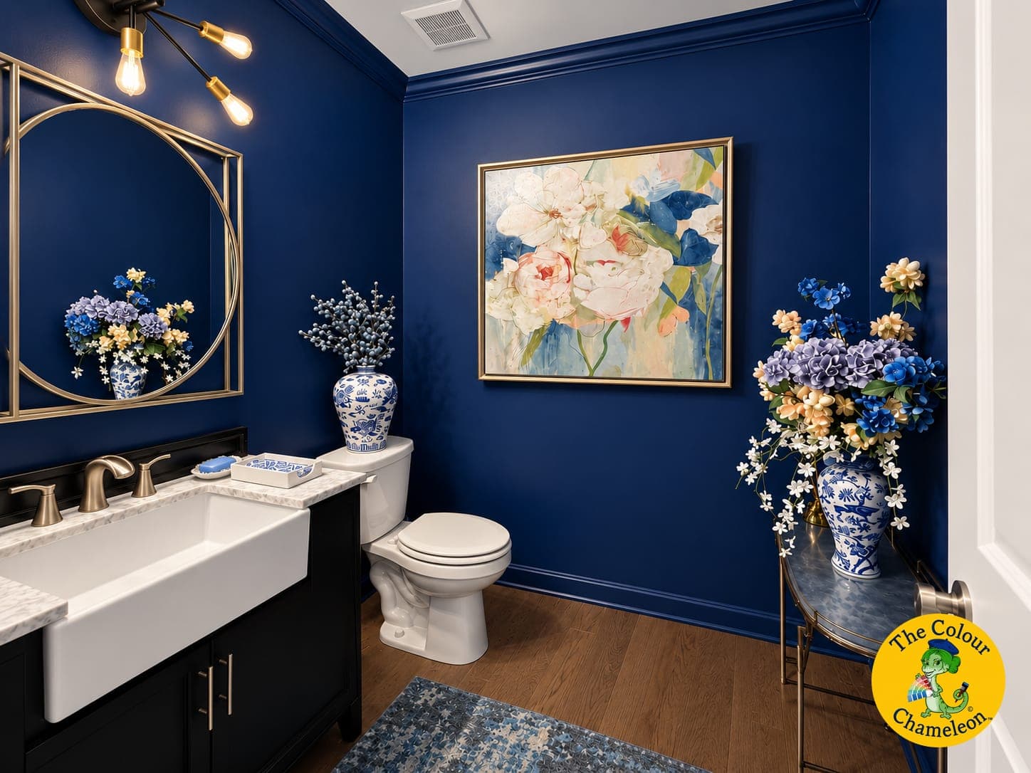 The same powder room with walls and trim drenched in deep blue and the mirror repainted gold