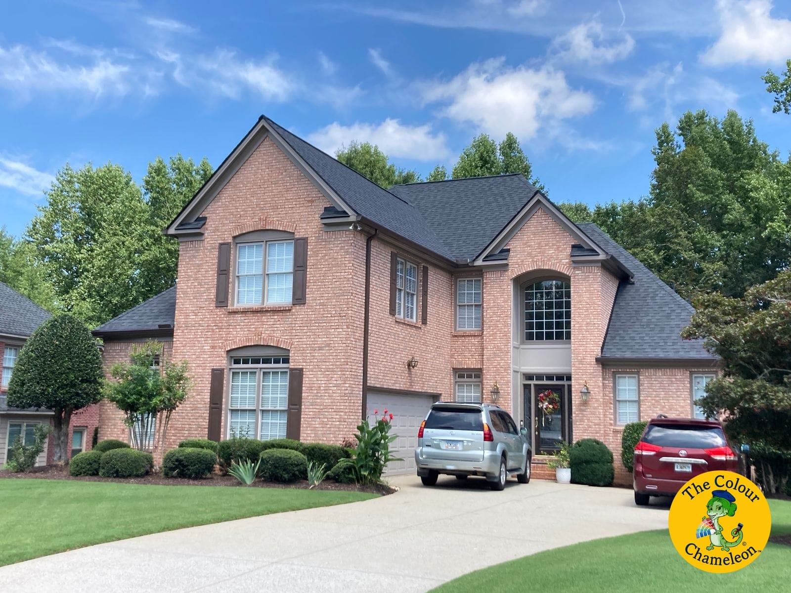 The same house with greige trim and a brown garage door, the brick now reading warm brown