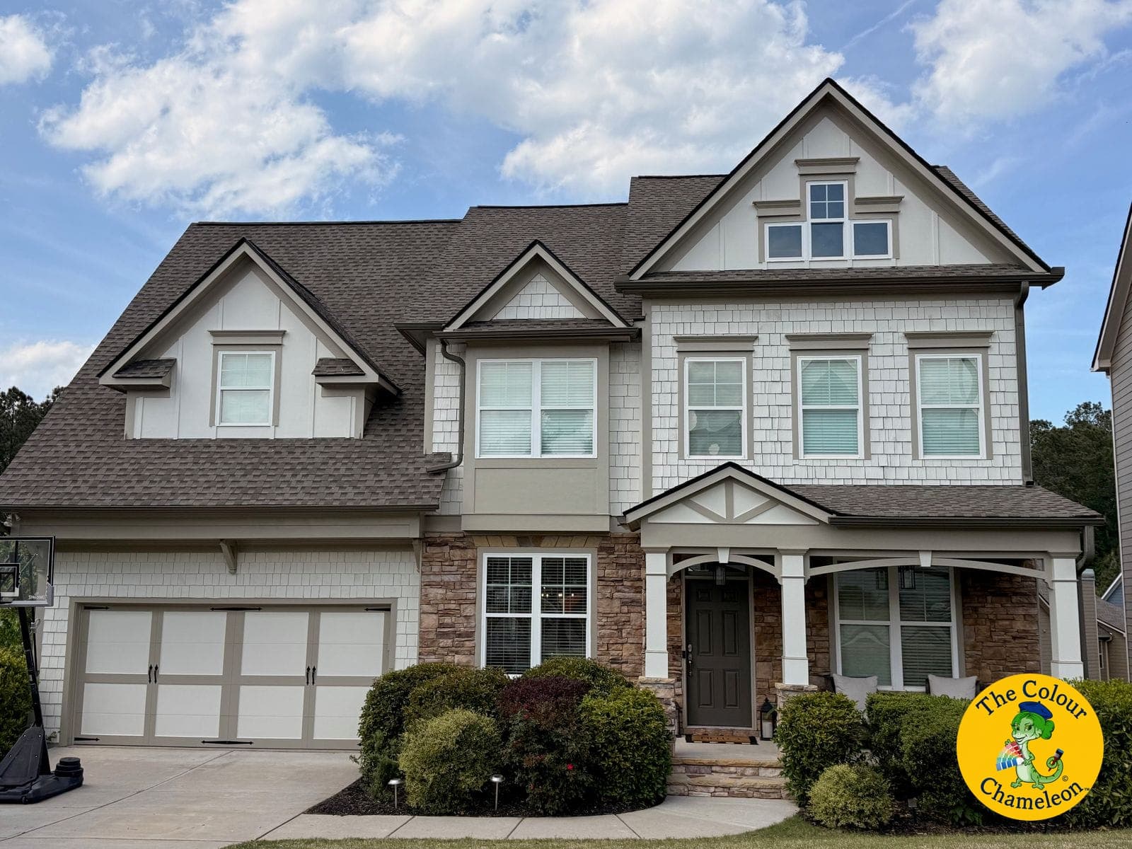 The same house in white siding and shakes with greige accents and a dark front door