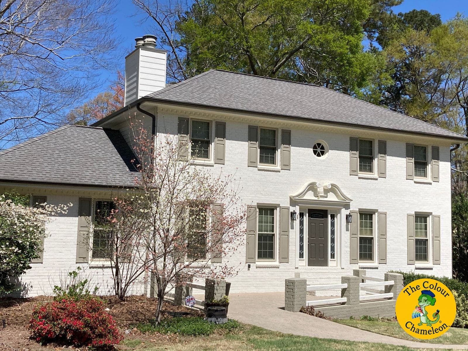 The same colonial with the brick painted white and the shutters repainted soft greige
