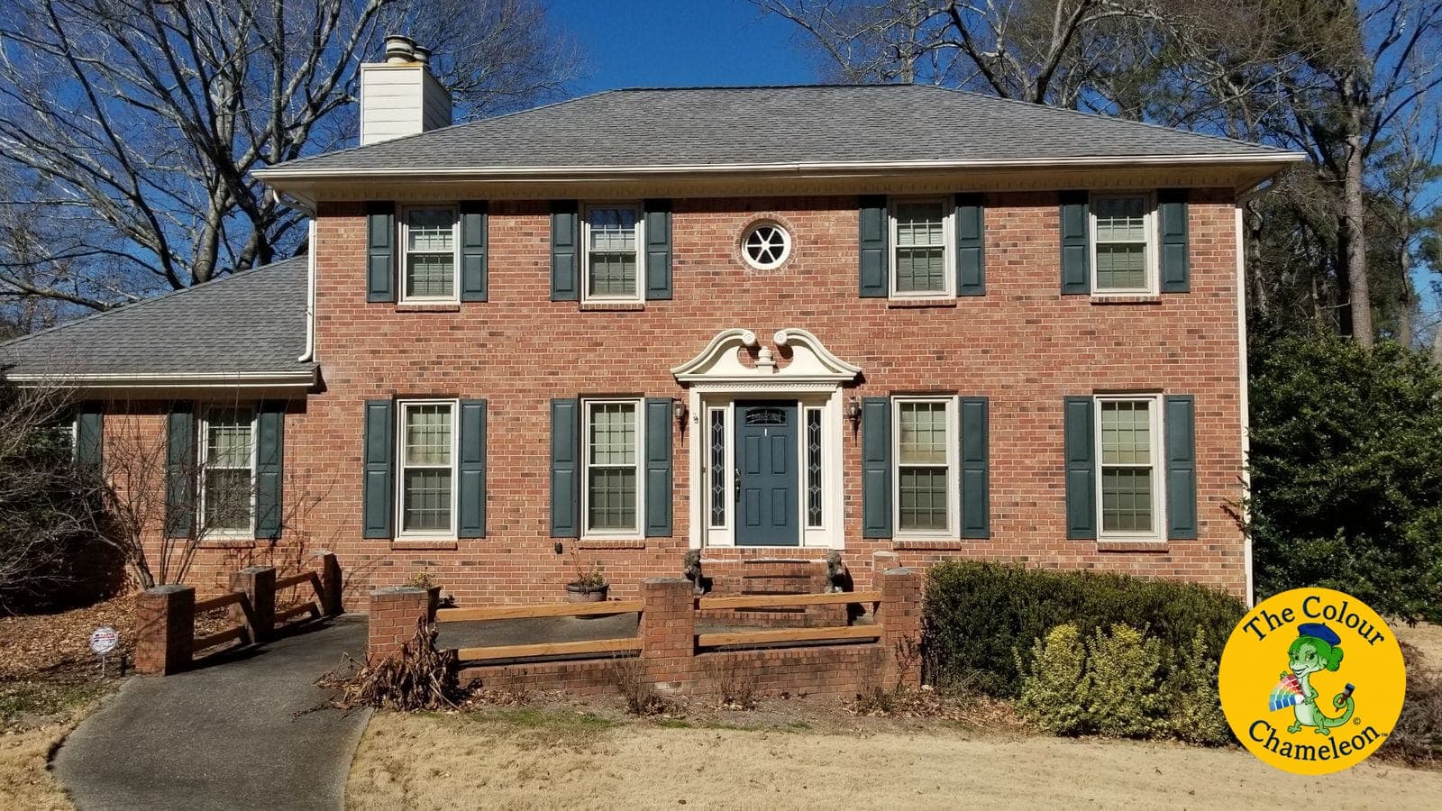 A red brick colonial with teal-green shutters and a white door surround