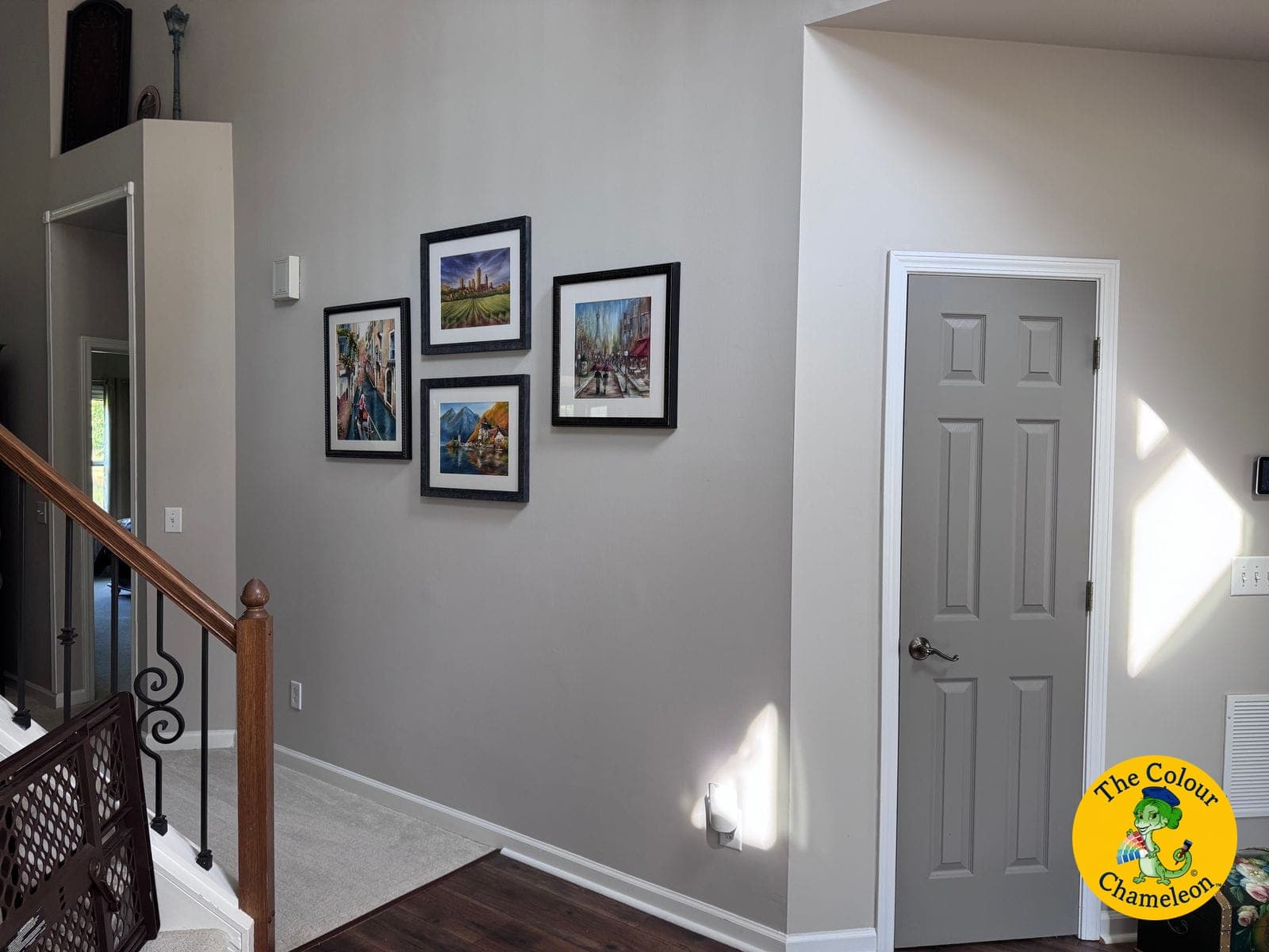 The same entry in cool gray with a five-piece gallery wall and the door painted to match