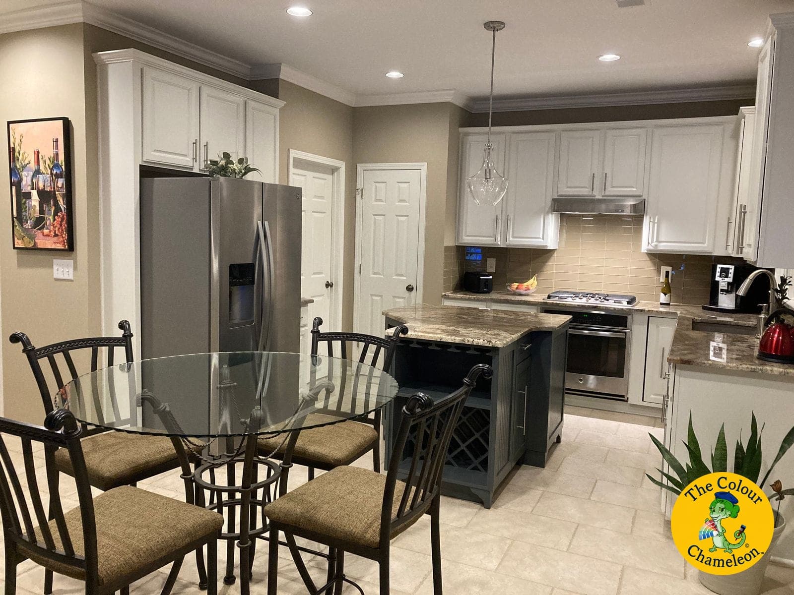The same kitchen with white cabinets, greige walls, stainless steel and a dark navy island
