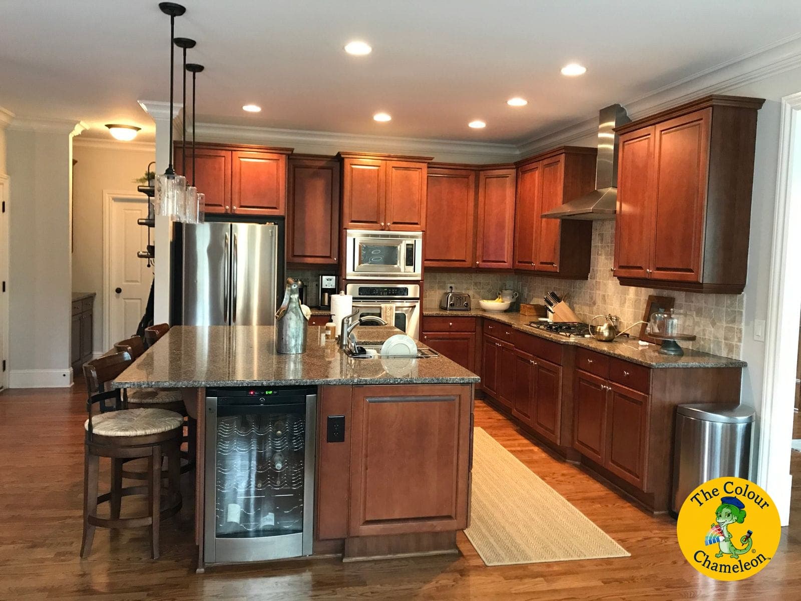 A kitchen of cherry-stained cabinets with a matching cherry island