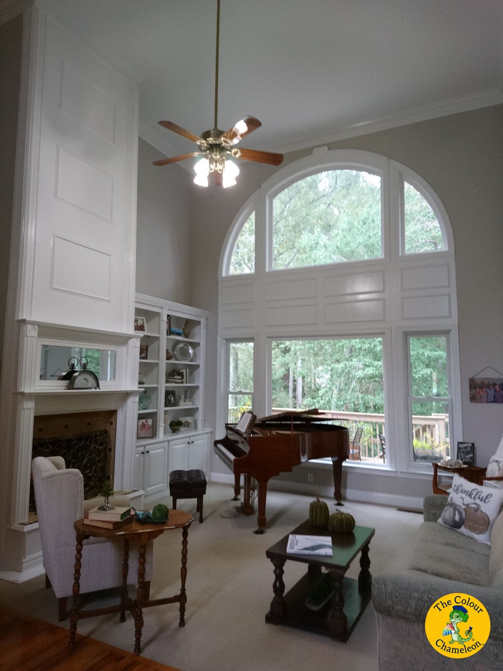 The same room in soft gray with white built-ins and a grand piano at the window